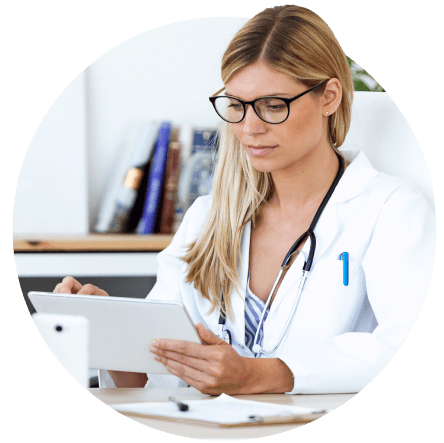 young white female doctor checking patient data on tablet